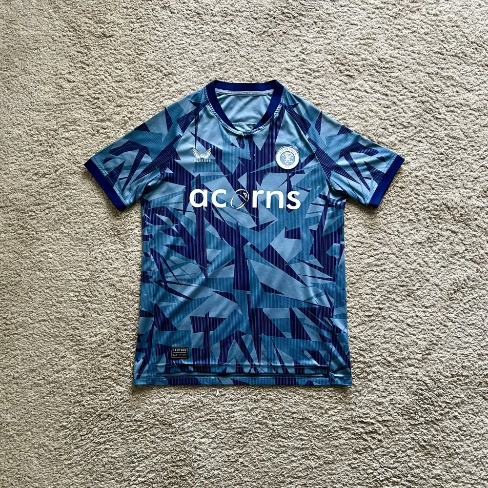 Front view of Aston Villa 2023/24 Castore 3rd Shirt (Acorns) - Junior XL
